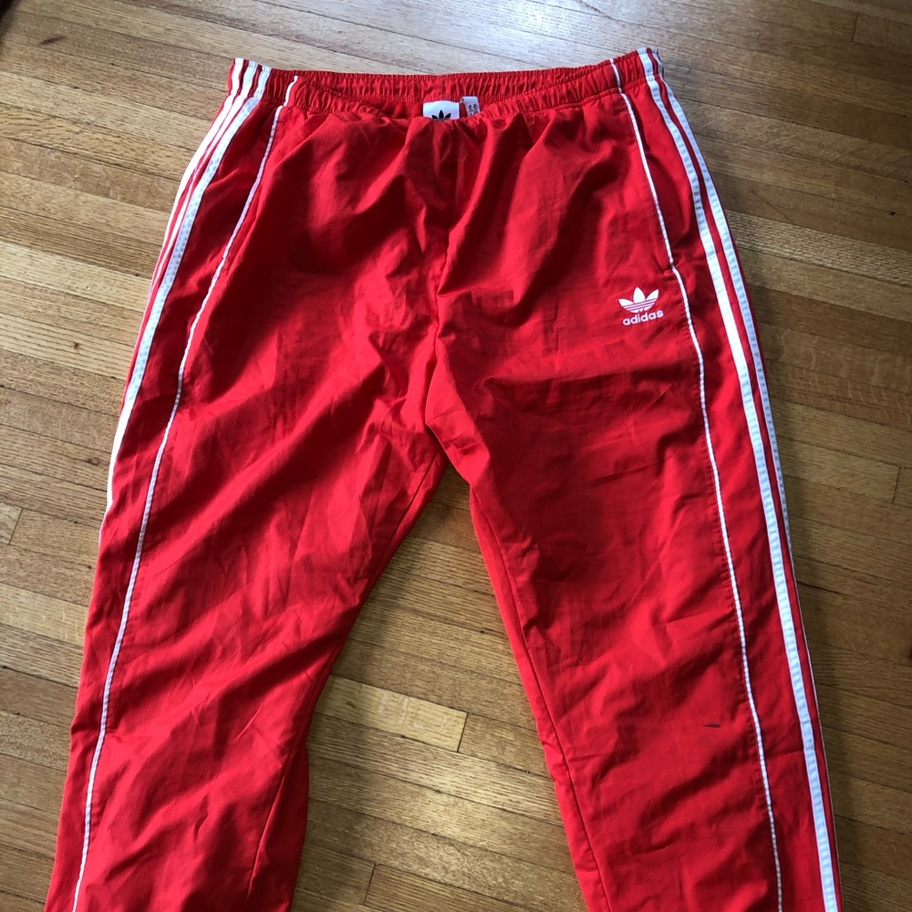 Adidas Red trackpants sold by Urban Outfitters
